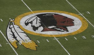 FILE - In this Aug. 7, 2014 file photo, the Washington Redskins logo is seen on the field before an NFL football preseason game against the New England Patriots in Landover, Md. A First Amendment fight will play out Wednesday, Jan. 18, 2017,  in the Supreme Court as the justices consider whether a law barring disparaging trademarks violates free speech rights.  (AP Photo/Alex Brandon, File)