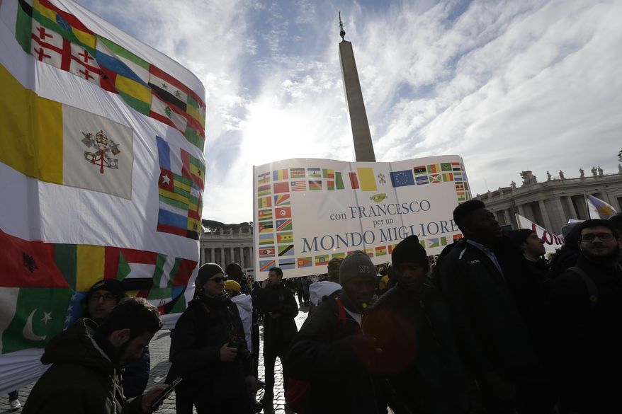 Migrants hold a banner adorned with the flags of various African countries which reads: " With Francis for a better world " as they gather in St. Peter's Square to attend the Angelus noon prayer delivered by Pope Francis at the Vatican, Sunday, Jan.15, 2017. (AP Photo/Andrew Medichini)