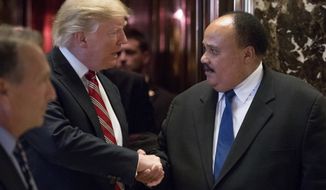 President-elect Donald Trump shakes hands with Martin Luther King III, son of Martin Luther King Jr. at Trump Tower in New York, Monday, Jan. 16, 2017. (AP Photo/Andrew Harnik)