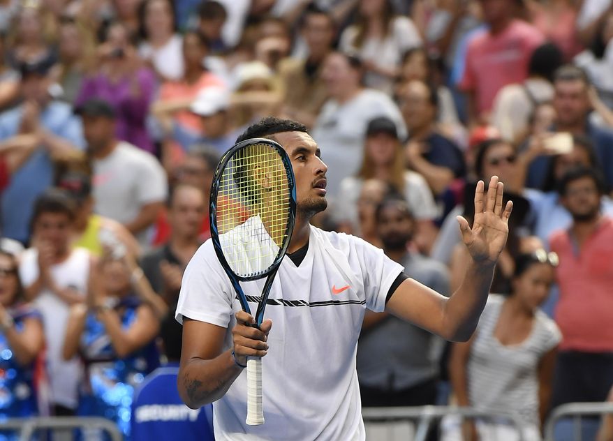 Australia's Nick Kyrgios waves to the crowd after defeating Portugal's Gasto Elias in their first round match at the Australian Open tennis championships in Melbourne, Australia, Monday, Jan. 16, 2017. (AP Photo/Andy Brownbill)
