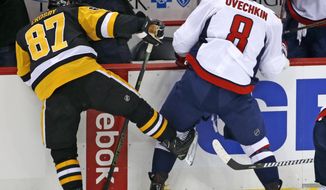 Pittsburgh Penguins&#x27; Sidney Crosby (87) collides with Washington Capitals&#x27; Alex Ovechkin (8) in the first period of an NHL hockey game in Pittsburgh, Monday, Jan. 16, 2017. (AP Photo/Gene J. Puskar)