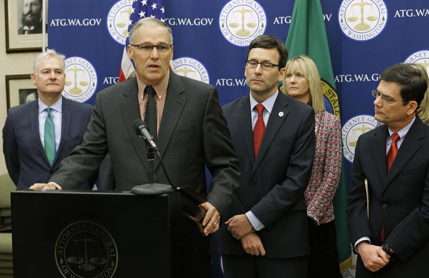 Washington Gov. Jay Inslee, second from left, speaks Monday, Jan. 16, 2017, during a news conference at the Capitol in Olympia, Wash., to announce that he and Attorney General Bob Ferguson, third from left, have proposed legislation to abolish the death penalty in Washington state. (AP Photo/Ted S. Warren)