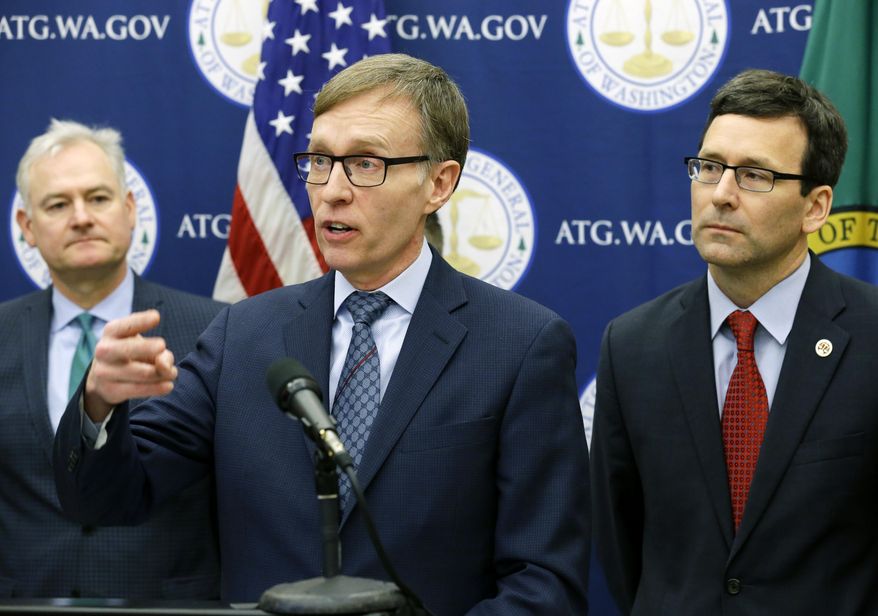 Former Attorney General Rob McKennam, center, speaks Monday, Jan. 16, 2017, during a news conference at the Capitol in Olympia, Wash., to announce that current Attorney General Bob Ferguson, right, and Washington Gov. Jay Inslee (not shown) have proposed legislation to abolish the death penalty in Washington state. (AP Photo/Ted S. Warren)