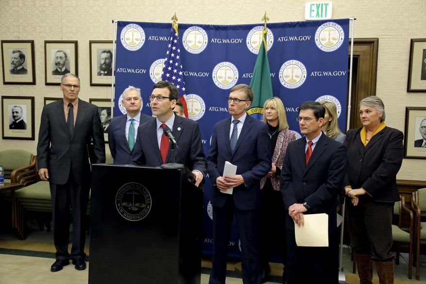 Attorney General Bob Ferguson, third from left, is flanked by supporters, including Washington Gov. Jay Inslee, left, and former Attorney General Rob McKenna, fourth from left, as he speaks Monday, Jan. 16, 2017, during a news conference at the Capitol in Olympia, Wash., to announce that he and Inslee have proposed legislation to abolish the death penalty in Washington state. (AP Photo/Ted S. Warren)