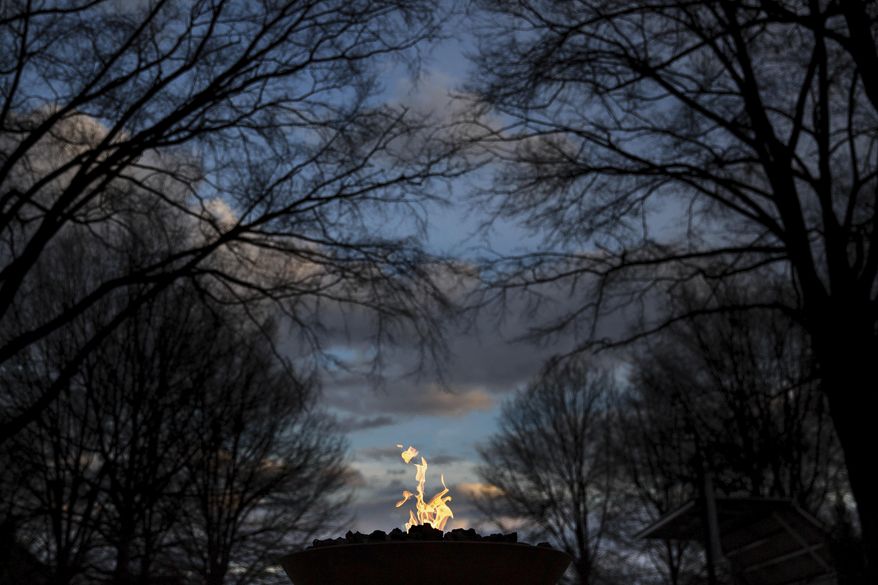 An eternal flame burns at the gravesite of Rev. Martin Luther King Jr., Monday, Jan. 16, 2017, in Atlanta. (AP Photo/Branden Camp)