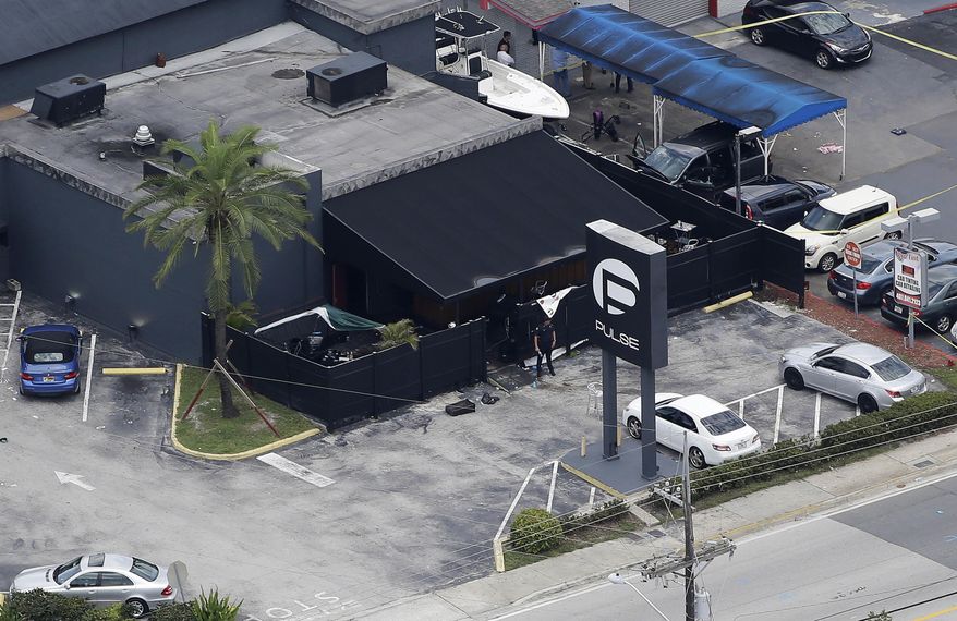 In this June 12, 2016 file photo, law enforcement officials work at the Pulse gay nightclub in Orlando, Fla., following the a mass shooting. (AP Photo/Chris O'Meara, File) **FILE**