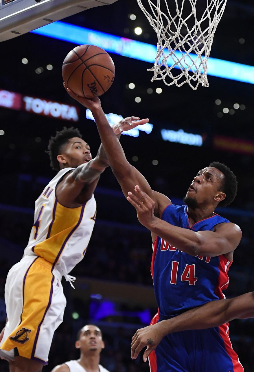 Detroit Pistons guard Ish Smith, right, shoots as Los Angeles Lakers forward Brandon Ingram defends during the first half of an NBA basketball game, Sunday, Jan. 15, 2017, in Los Angeles. (AP Photo/Mark J. Terrill)