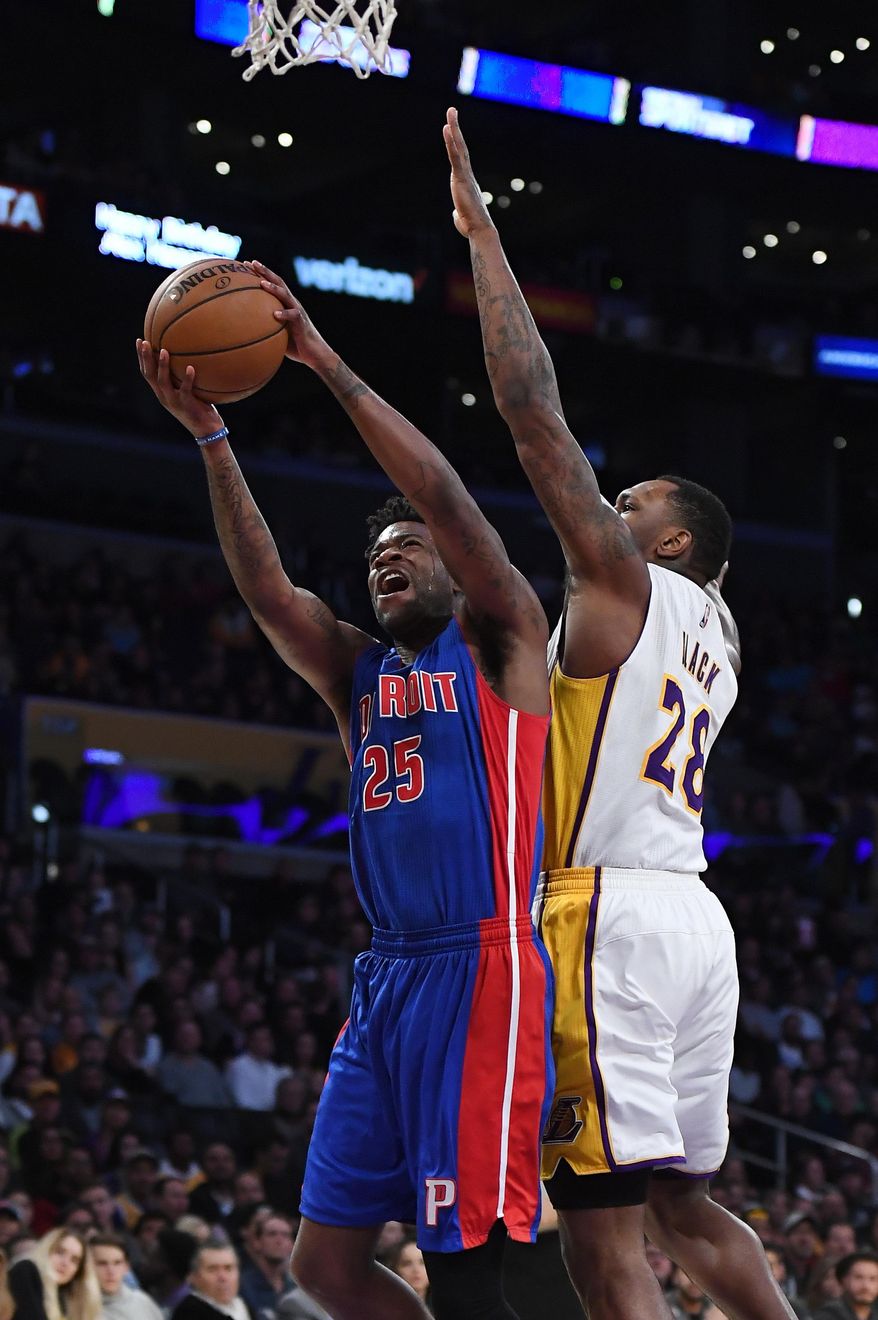 Detroit Pistons forward Reggie Bullock, left, shoots as Los Angeles Lakers center Tarik Black defends during the first half of an NBA basketball game, Sunday, Jan. 15, 2017, in Los Angeles. (AP Photo/Mark J. Terrill)