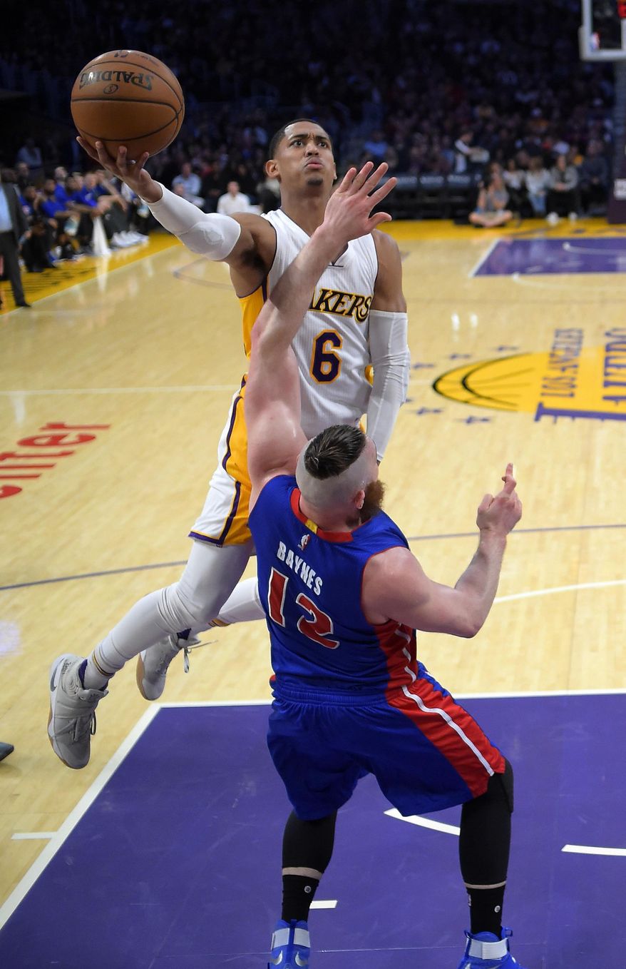 Los Angeles Lakers guard Jordan Clarkson, top, shoots as Detroit Pistons center Aron Baynes, of Australia, defends during the first half of an NBA basketball game, Sunday, Jan. 15, 2017, in Los Angeles. (AP Photo/Mark J. Terrill)
