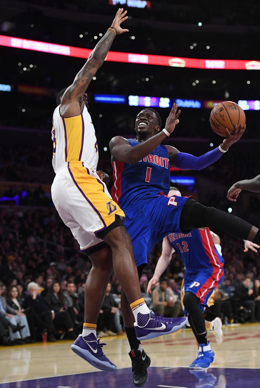 Detroit Pistons guard Reggie Jackson, right, of Italy, shoots as Los Angeles Lakers center Tarik Black defends during the first half of an NBA basketball game, Sunday, Jan. 15, 2017, in Los Angeles. (AP Photo/Mark J. Terrill)