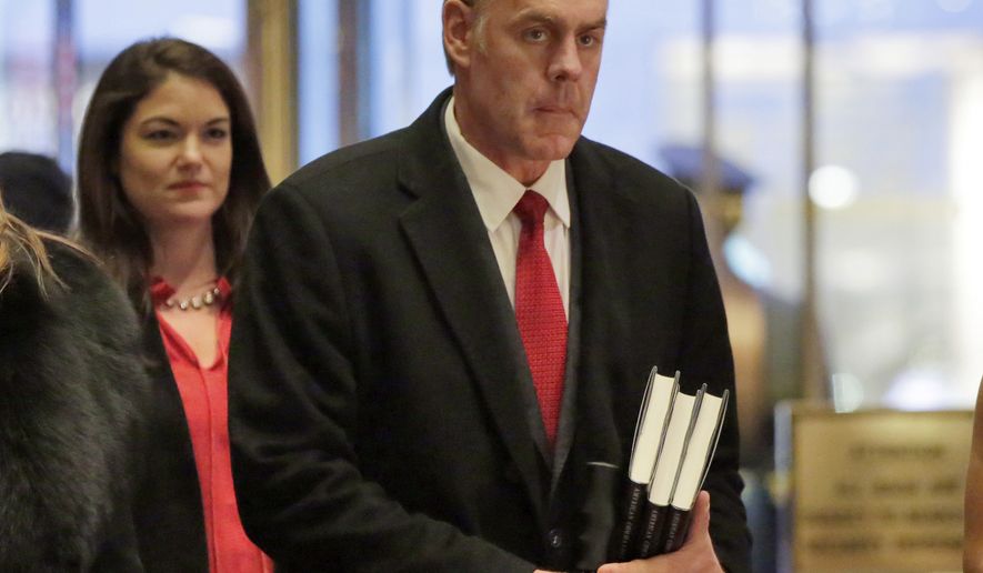 FILE - In this Dec. 12, 2016, file photo, Interior Secretary-designate Rep. Ryan Zinke, right, R-Mont., arrives in Trump Tower, in New York, Monday, Dec. 12, 2016. Zinke says he would never sell, give away or transfer public lands, a crucial stance in his home state of Montana and the West, where access to hunting and fishing is considered sacrosanct. (AP Photo/Richard Drew, File)
