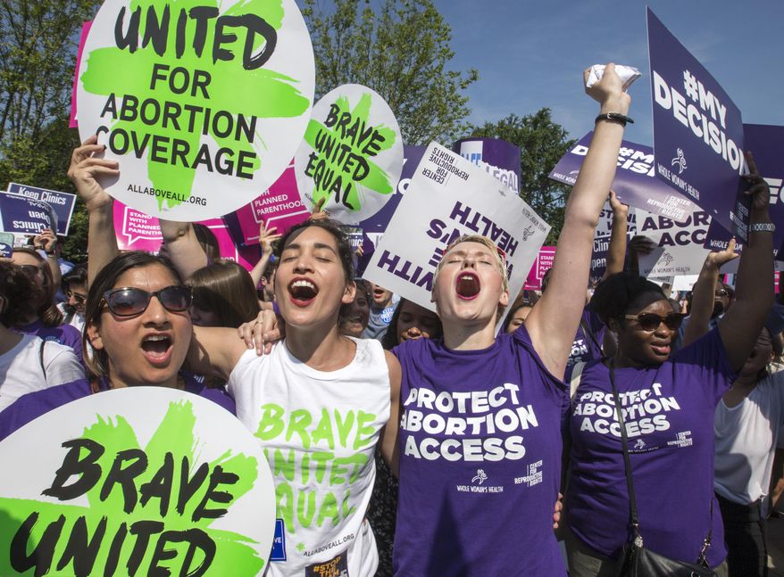 FILE - In a Monday, June 27, 2016 file photo, abortion rights activists, from left, Ravina Daphtary of Philadelphia, Morgan Hopkins of Boston, and Alison Turkos of New York City, rejoice in front of the Supreme Court in Washington, as the justices struck down the strict Texas anti-abortion restriction law known as HB2. Even as the 2016 election outcome intensifies America's abortion debate, a comprehensive new survey released Tuesday, Jan. 17, 2017 by the Guttmacher Institute finds the annual number of abortions in the U.S has dropped to well under 1 million, the lowest level since 1974. (AP Photo/J. Scott Applewhite, File)