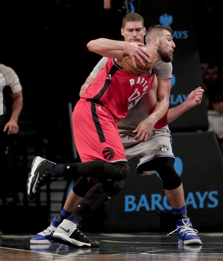 Toronto Raptors center Jonas Valanciunas (17) drives against Brooklyn Nets center Brook Lopez during the third quarter of an NBA basketball game, Tuesday, Jan. 17, 2017, in New York. The Raptors won 119-109. (AP Photo/Julie Jacobson)