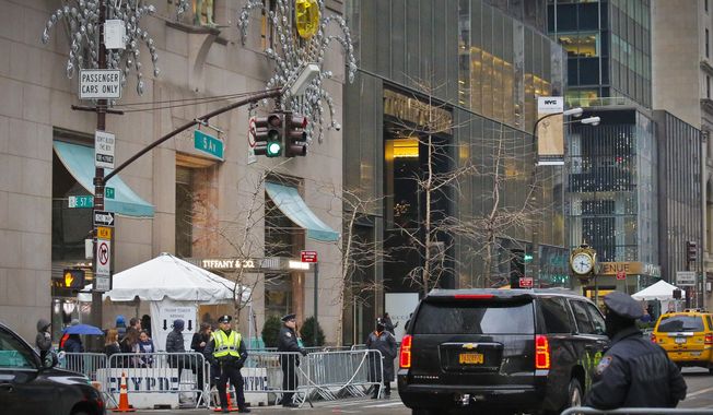 Police secure the area around Trump Tower and its neighbor Tiffany with barriers and a screening tent, Tuesday Jan. 17, 2017, in New York.  Tiffany said Tuesday that sales at its store on Manhattan&#x27;s 5th Avenue tumbled 14 percent in November and December, compared with the same period last year, partly due to &amp;quot;post-election traffic disruptions.&amp;quot;(AP Photo/Bebeto Matthews)