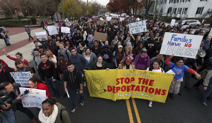 Hundreds of Rutgers University students block College Ave., in New Brunswick, N.J., as they march to protest some of President elect Donald Trump&#39;s policies and to ask school officials to denounce some of his plans at Rutgers University Wednesday, Nov. 16, 2016, in New Brunswick, N.J. College students at campuses around the United States say they are planning rallies and walkouts to call on school administrators to protect students and employees against immigration proceedings under Donald Trump&#39;s presidency. (AP Photo/Mel Evans)
