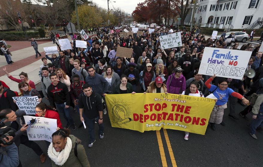 Hundreds of Rutgers University students block College Ave., in New Brunswick, N.J., as they march to protest some of President elect Donald Trump's policies and to ask school officials to denounce some of his plans at Rutgers University Wednesday, Nov. 16, 2016, in New Brunswick, N.J. College students at campuses around the United States say they are planning rallies and walkouts to call on school administrators to protect students and employees against immigration proceedings under Donald Trump's presidency. (AP Photo/Mel Evans)