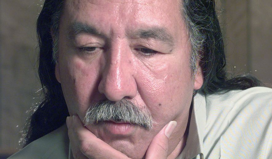 FILE - In this April 29, 1999, file photo, American Indian activist Leonard Peltier speaks during an interview at the U.S. Penitentiary at Leavenworth, Kan. Longtime supporters of Peltier are hoping President Barack Obama will grant him clemency before leaving office. Peltier is serving two life sentences for the 1975 shooting deaths of two FBI agents during a standoff on South Dakota&#39;s Pine Ridge Indian Reservation. (Joe Ledford/The Kansas City Star via AP, File)