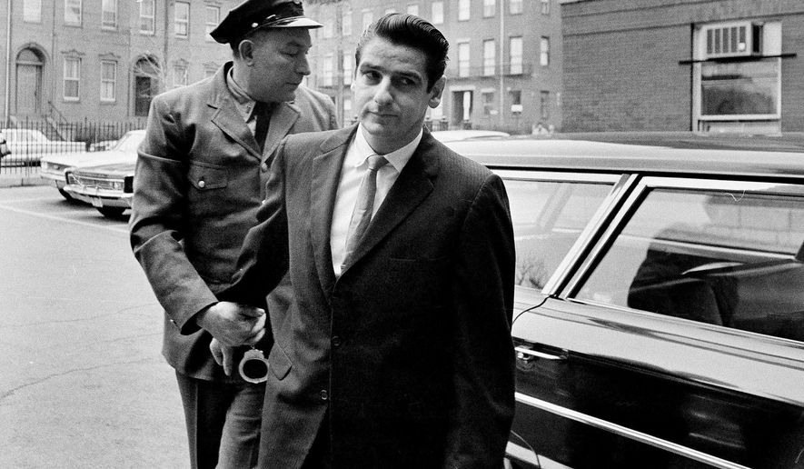 FILE - In this Jan. 10, 1967, file photo shows Albert DeSalvo, right, arrives for a court appearance in Cambridge, Mass. Fifty years ago a judge sentenced DeSalvo, a factory worker who claimed he was the notorious Boston Strangler, but questions still swirl around DeSalvo's confession. (AP Photo, File)