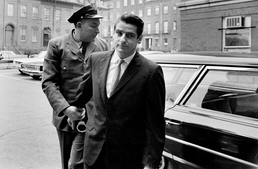 FILE - In this Jan. 10, 1967, file photo shows Albert DeSalvo, right, arrives for a court appearance in Cambridge, Mass. Fifty years ago a judge sentenced DeSalvo, a factory worker who claimed he was the notorious Boston Strangler, but questions still swirl around DeSalvo's confession. (AP Photo, File)
