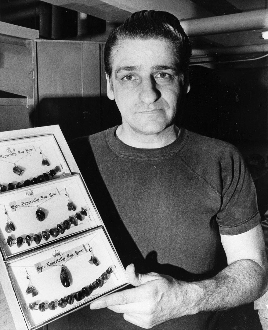 FILE - In this March 18, 1973, file photo, Albert DeSalvo, the self-confessed "Boston strangler," displays jewelry created while serving his sentence at Walpole State Prison in Walpole, Mass. Fifty years ago a judge sentenced DeSalvo, a factory worker who claimed he was the notorious Boston Strangler, but questions still swirl around DeSalvo's confession. (AP Photo/Bill Chaplis, File)