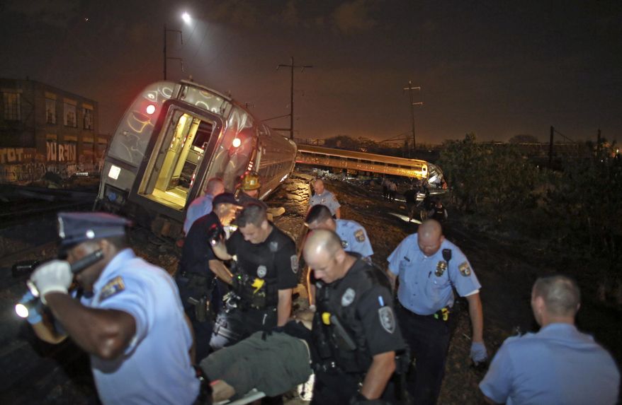 FILE – In this May 12, 2015, file photo, emergency personnel work near the wreckage of a New York City-bound Amtrak train following a derailment that killed eight people in Philadelphia. Federal Railroad Administrator Sarah Feinberg leaves office Friday, Jan. 20, 2017, after a two-year tenure as the nation's chief railroad regulator, championing safety and technology initiatives that remain a work in progress. (AP Photo/Joseph Kaczmarek, File)