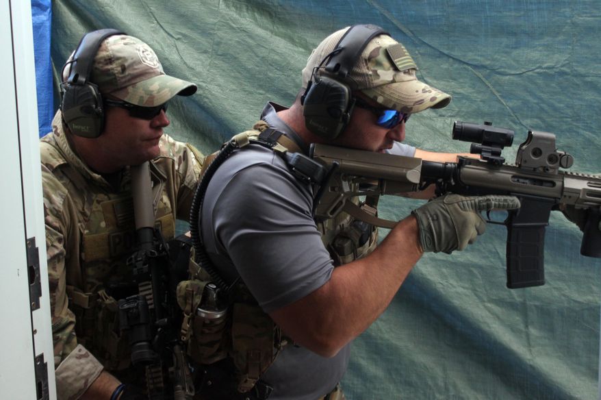 ADVANCE FOR WEEKEND EDITIONS, JAN. 21-22 - In this Jan. 12, 2017 photo, tactical medic Earl Phelps works on a simulated hostage rescue training exercise 12 at the Carlsbad Action Sports Complex in Carlsbad, N.M. Phelps is part of 12-man SWAT team in Carlsbard. (Adrian Hedden/Carlsbad Current Argus via AP)