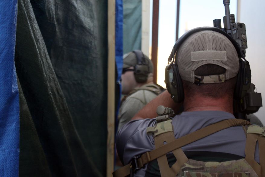 ADVANCE FOR WEEKEND EDITIONS, JAN. 21-22 - In this Jan. 12, 2017 photo, tactical medic Earl Phelps practices a rescue mission with the Carlsbad Special Weapons and Tactics team at the Carlsbad Action Sports Complex in Carlsbad, N.M. Phelps is part of 12-man SWAT team in Carlsbard. (Adrian Hedden/Carlsbad Current Argus via AP)