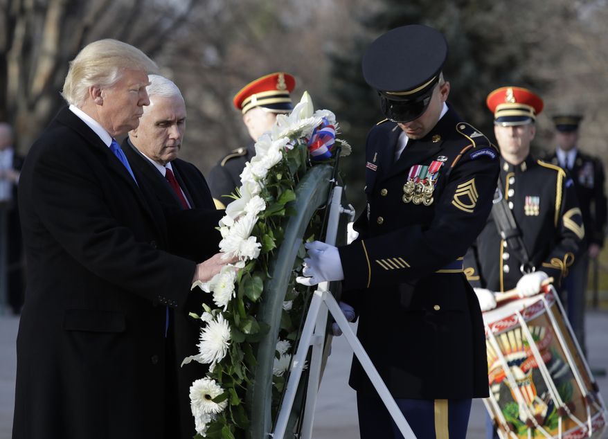 President-elect Donald Trump, accompanied by Vice President-elect Mike Pence places a wreath at the Tomb of the Unknowns, Thursday, Jan. 19, 2017, at Arlington National Cemetery in Arlington, Va., ahead of Friday&#39;s presidential inauguration. (AP Photo/Evan Vucci)