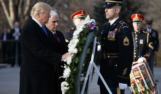 President-elect Donald Trump, accompanied by Vice President-elect Mike Pence places a wreath at the Tomb of the Unknowns, Thursday, Jan. 19, 2017, at Arlington National Cemetery in Arlington, Va., ahead of Friday&#39;s presidential inauguration. (AP Photo/Evan Vucci)