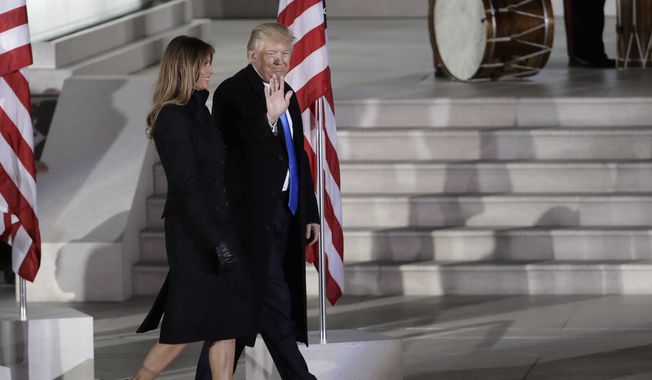 President-elect Donald Trump and his wife Melania Trump walk at a pre-Inaugural &quot;Make America Great Again! Welcome Celebration&quot; at the Lincoln Memorial in Washington, Thursday, Jan. 19, 2017. (AP Photo/David J. Phillip)