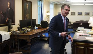 Secretary of Defense Ash Carter holds a Marine Corps Ka-Bar fighting knife while being interviewed in his Pentagon office, Wednesday, Jan. 18, 2017. The knife was given to him earlier in the day by his Senior Miltary Assistant Marine Brig. Gen. Eric Smith and was carried by Smith on all of his deployments. Sending thousands more American troops into Iraq or Syria in a bid to accelerate the defeat of the Islamic State group would push U.S. allies to the exits, create more anti-U.S. resistance and give up the U.S. military’s key advantages, Carter said in an Associated Press interview. (AP Photo/Cliff Owen)