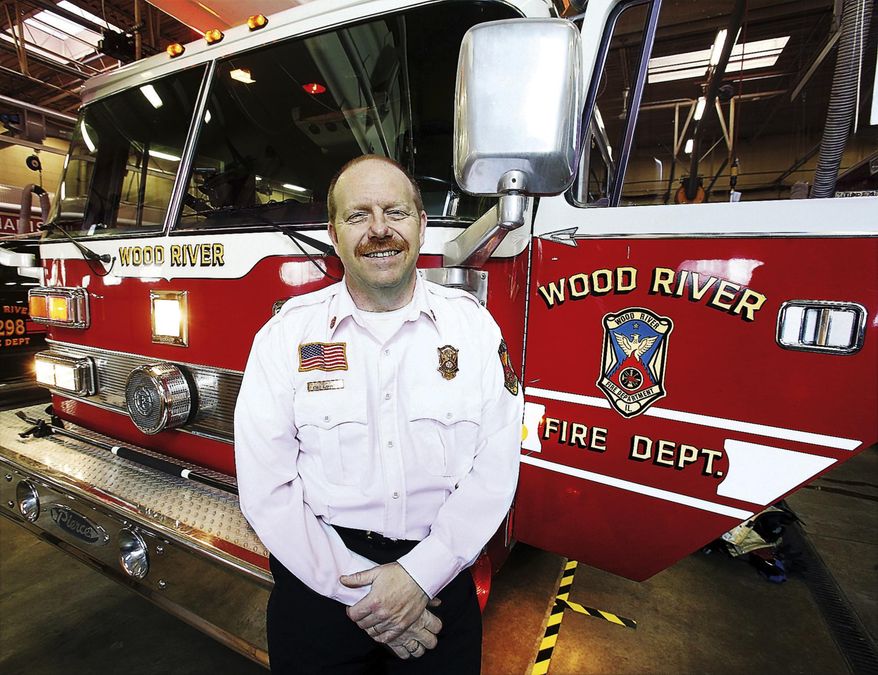 ADVANCE FOR USE SUNDAY, JAN. 22, 2017 AND THEREAFTER - In this Jan. 6, 2017 photo, Wood River, Ill., Fire Chief Steve Alexander poses in front of the department's Snorkel truck. Alexander who has led the Wood River department for more than three decades, is retiring. He says he has no immediate plans for his retirement except working on projects around his house. (John Badman/The Telegraph via AP)