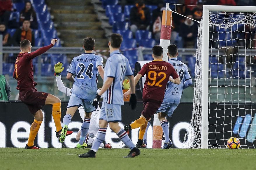 Roma's Edin Dzeko, left, scores during an Italian Cup, round of 16, soccer match between Roma and Sampdoria, at Rome's Olympic stadium, Thursday, Jan. 19, 2017. (Angelo Carconi/ANSA via AP)