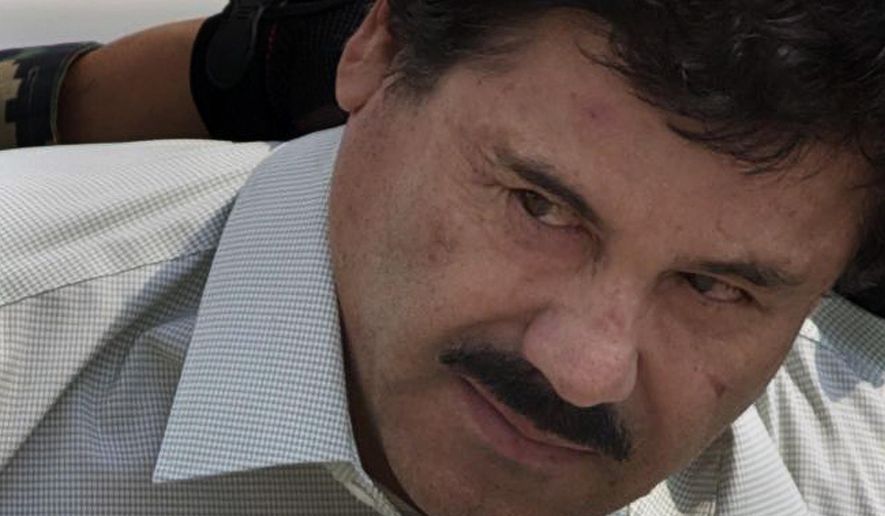 FILE - In this Feb. 22, 2014 file photo, Joaquin "El Chapo" Guzman is escorted to a helicopter in handcuffs by Mexican navy marines at a navy hanger in Mexico City. According to Mexico's Foreign Ministry, Guzman has been extradited to the United States on Thursday, Jan. 19 2017. (AP Photo/Eduardo Verdugo, File)