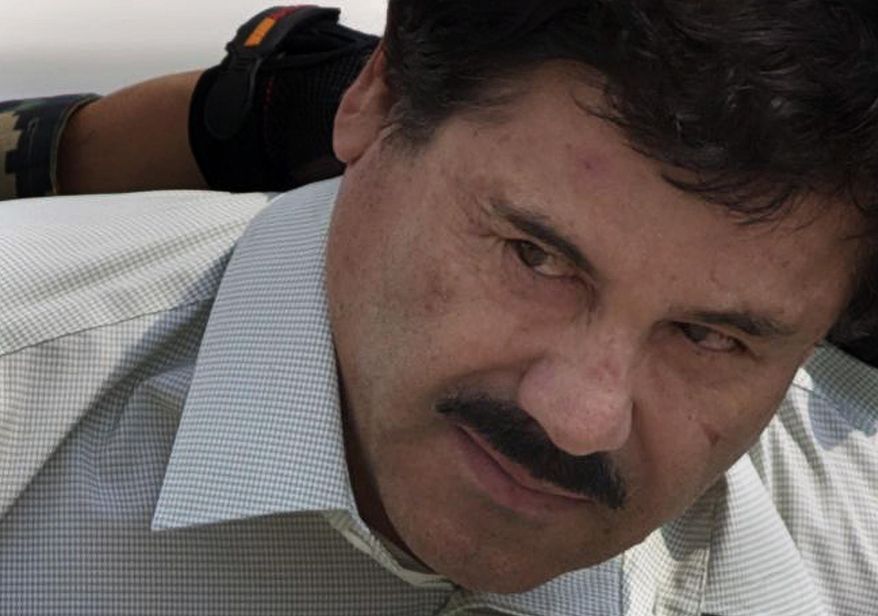 FILE - In this Feb. 22, 2014 file photo, Joaquin "El Chapo" Guzman is escorted to a helicopter in handcuffs by Mexican navy marines at a navy hanger in Mexico City. According to Mexico's Foreign Ministry, Guzman has been extradited to the United States on Thursday, Jan. 19 2017. (AP Photo/Eduardo Verdugo, File)