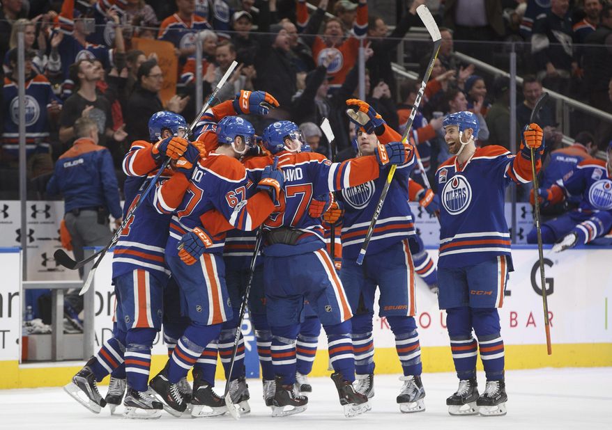 Edmonton Oilers celebrate their overtime win over the Florida Panthers in an NHL hockey game Wednesday, Jan. 18, 2017, in Edmonton, Alberta. (Jason Franson/The Canadian Press via AP)