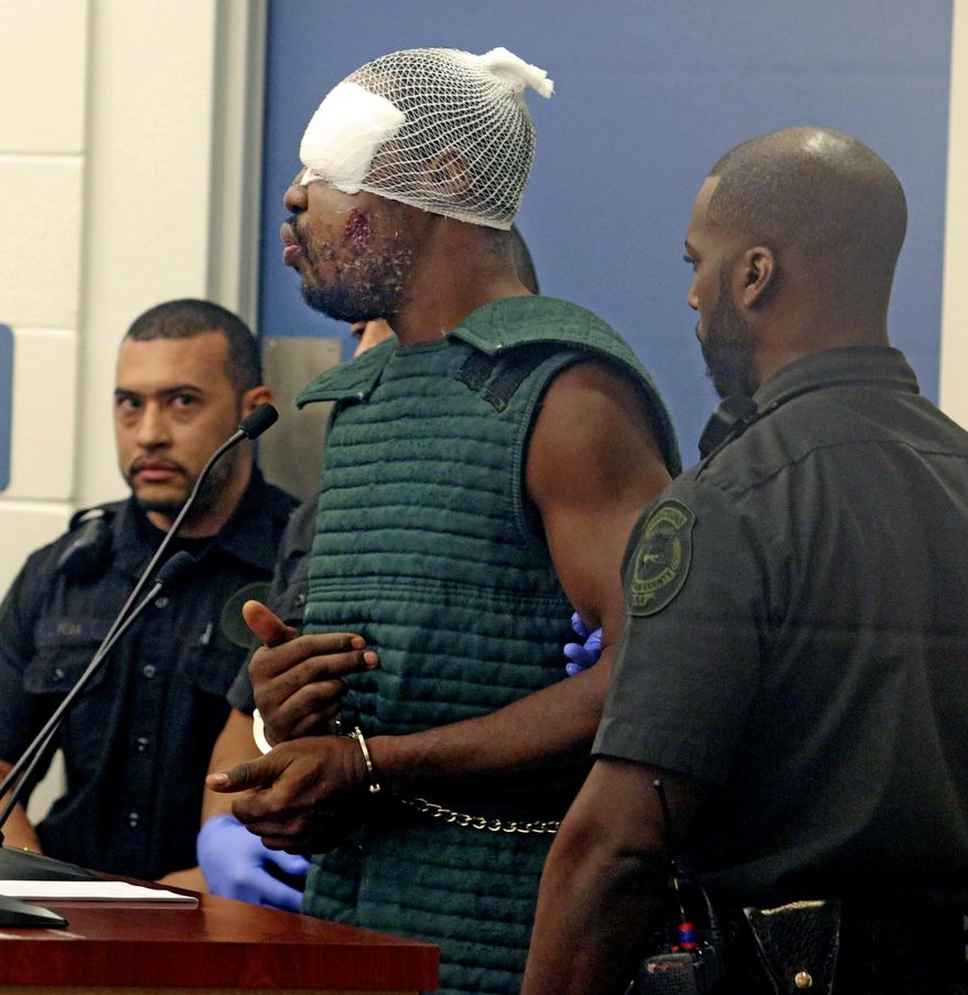 Markeith Loyd, suspected of fatally shooting a Florida police officer, attends his initial court appearance Thursday, Jan. 19, 2017, at the Orange County Jail, in Orlando, Fla. Loyd spoke out of turn and was defiant during the appearance on charges of killing his pregnant ex-girlfriend. He was injured during his arrest Tuesday night following a weeklong manhunt. (Red Huber/Orlando Sentinel via AP, Pool)