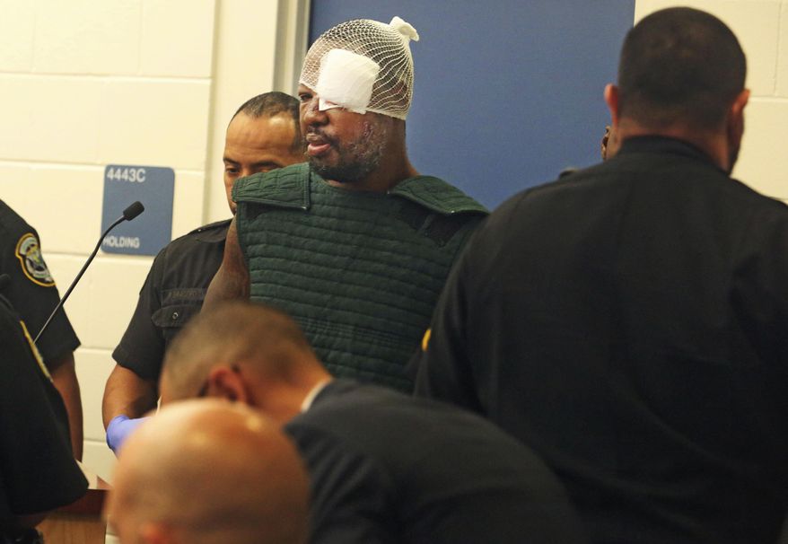 Markeith Loyd, suspected of fatally shooting a Florida police officer, attends his initial court appearance Thursday, Jan. 19, 2017, at the Orange County Jail, in Orlando, Fla. Loyd spoke out of turn and was defiant during the appearance on charges of killing his pregnant ex-girlfriend. He was injured during his arrest Tuesday night following a weeklong manhunt. (Red Huber/Orlando Sentinel via AP, Pool)
