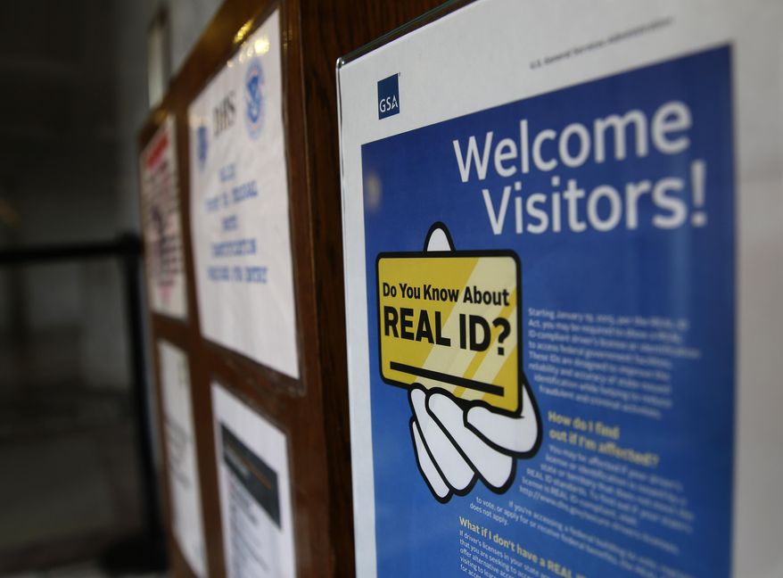 FILE - In this photo taken April 6, 2016, a sign at the federal courthouse in Tacoma, Wash., is shown to inform visitors of the federal government's REAL ID act, which requires state driver's licenses and ID cards to have security enhancements and be issued to people who can prove they're legally in the United States. Lawmakers in Washington state are now trying to bring the state in compliance with the law, and if state-issued identification cards and licenses are not changed, residents may have to produce additional forms of ID when boarding domestic flights at U.S. airports beginning in January, 2018. (AP Photo/Ted S. Warren, file)