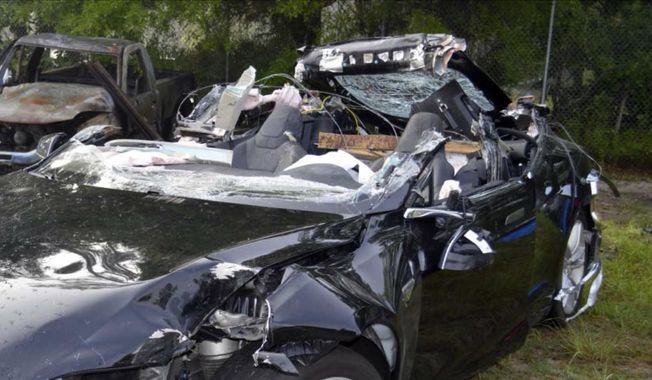 In this photo provided by the National Transportation Safety Board via the Florida Highway Patrol shows a Tesla Model S that was being driven by Joshua Brown, who was killed when the Tesla sedan crashed while in self-driving mode on May 7, 2016. A source tells The Associated Press that U.S. safety regulators are ending an investigation into a fatal crash involving electric car maker Tesla Motors&#x27; Autopilot system without a recall. (NTSB via Florida Highway Patrol via AP, File)