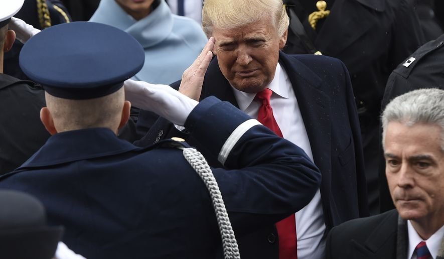 President Donald Trump salutes military personnel as he leaves Capitol Hill in Washington, Friday, Jan. 20, 2017, after taking the presidential oath.  (Saul Loeb/Pool Photo via AP) ** FILE **