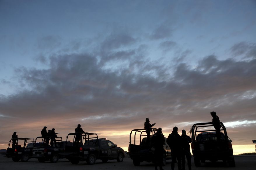 Federal police guard the entrance to the prison where drug lord Joaquin "El Chapo" Guzman was being held in Ciudad Juarez, Mexico, Thursday, Jan. 19, 2017. The infamous drug kingpin, who twice escaped from maximum-security prisons in Mexico, was extradited at the request of the U.S. to face drug trafficking and other charges and landed in New York late Thursday, a federal law enforcement official said. (AP Photo/Christian Torres)