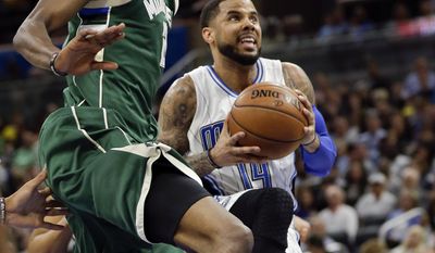 Orlando Magic&#x27;s D.J. Augustin, right, goes up for a shot against Milwaukee Bucks&#x27; Tony Snell, left, during the first half of an NBA basketball game, Friday, Jan. 20, 2017, in Orlando, Fla. (AP Photo/John Raoux)