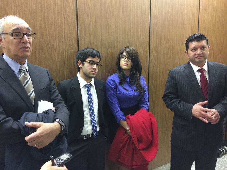 Crystal Crespo, second from right, and her brother, Daniel Nicholas Crespo, second from left, listen as the lawyers for their mother speak in a hallway of Los Angeles Superior Court in Los Angeles on Friday, Jan. 20, 2017. Lyvette Crespo was sentenced to three months in jail for the 2014 killing of their father, Daniel Crespo, the mayor of the small suburb of Bell Gardens. (AP Photo/Brian Melley)