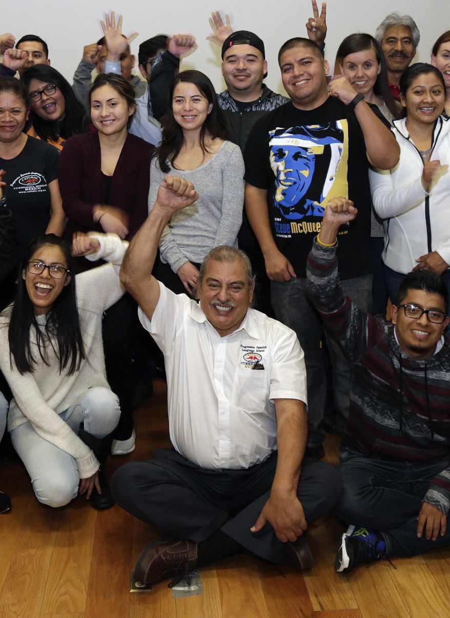ADVANCE FOR TUESDAY, JAN. 24, 2017 - In this Dec. 22, 2016 photo, Armando Vazquez-Ramos, lecturer in Chicano studies at California State University who leads a cross-border course, center, poses for a photo with his students in Mexico City. During a class session, Tamara Alcala Dominguez, who is at top left wearing glasses in this photo, heard from other migrants who were brought to the U.S. as children but were not there during DACA and either got deported or left voluntarily. Their stories, and the days spent reuniting with her grandmother, provided the glimpse she needed into what life would be like if deported. (AP Photo/Marco Ugarte)