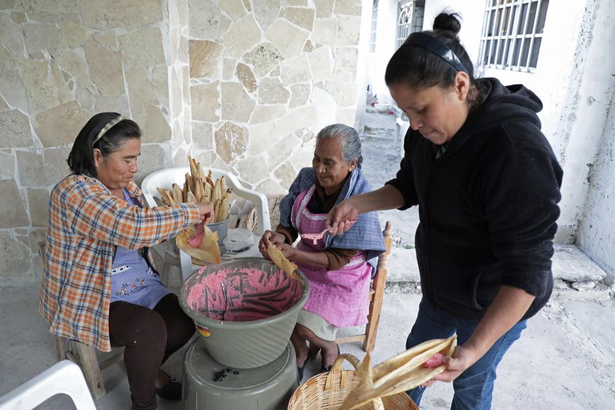 ADVANCE FOR TUESDAY, JAN. 24, 2017 - This Dec. 23, 2016 photo shows women making tamales in Molcaxac, Puebla state, Mexico. Folks here say so many working-age residents have migrated to the U.S., the town is mostly populated by the elderly and the very young. The first wave of migration started in 1942 with the bracero program, which allowed Mexicans to temporarily, and legally, work in the United States. After the program ended in 1964, people continued to go north illegally. (AP Photo/Pablo Spencer)