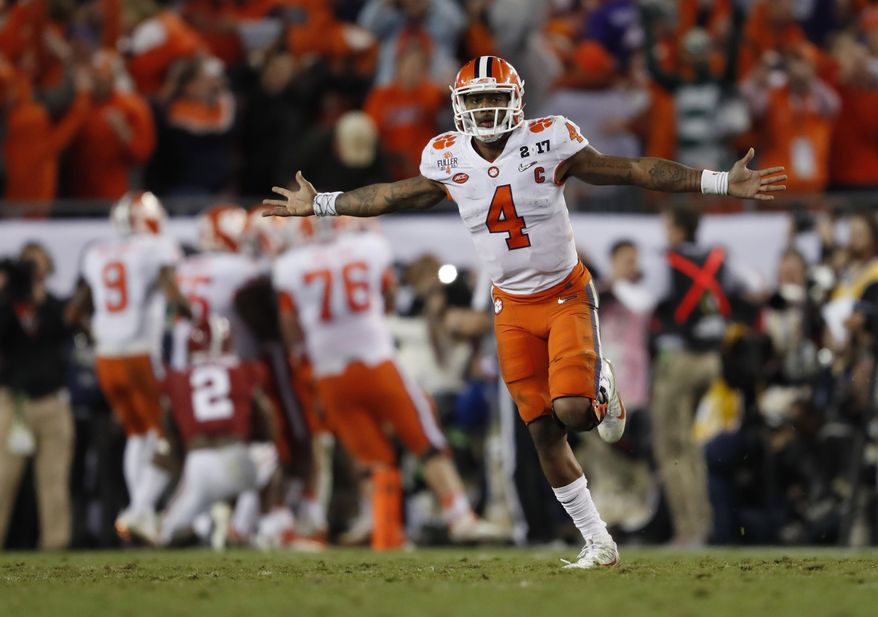 FILE - In this Jan. 10, 2017, file photo, Clemson's Deshaun Watson celebrates a last second touchdown pass to Hunter Renfrow during the second half of the NCAA college football playoff championship game against Alabama, in Tampa, Fla. The NFL on Friday, Jan. 20, 2017, released a list of 95 underclassmen who have been granted early entry to the draft, along with the names of eight other players, including Clemson quarterback Deshaun Watson, who are draft-eligible by completing their college degrees. (AP Photo/John Bazemore, File)