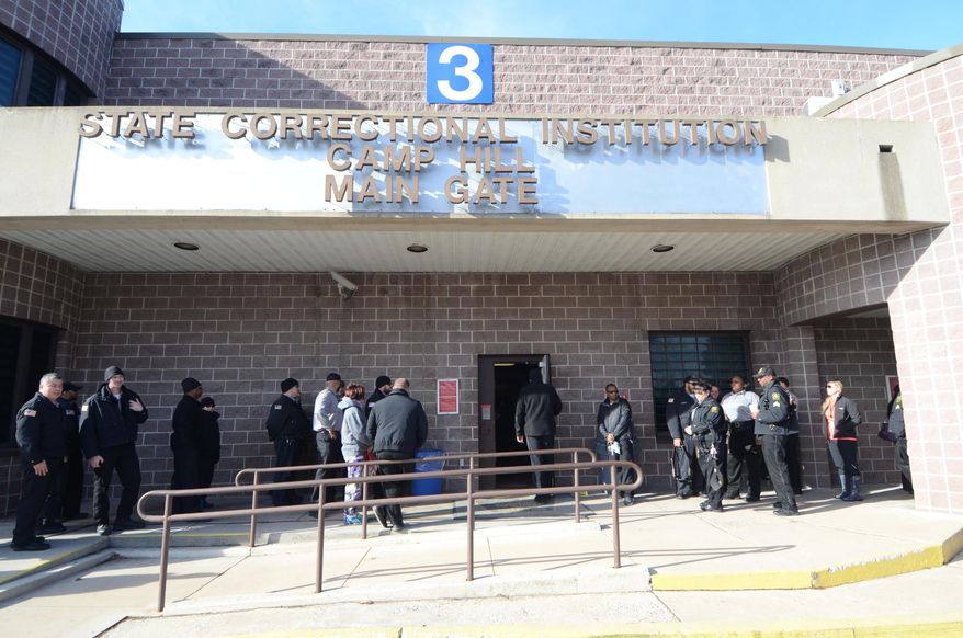 Correctsions officers arrive for their shift at the State Correctional Institution at Camp Hill, Pennsylvania, which is set to house inmates from other prisons that could close, Friday, Jan. 13, 2017, in Camp Hill, Pa. State officials say a 2012 Pennsylvania law contributing to shrinking state inmate ranks is also fueling a growing parolee population. (AP Photo/Marc Levy)
