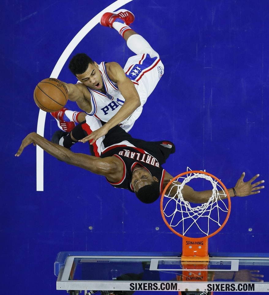 Philadelphia 76ers' Timothe Luwawu-Cabarrot, top, goes up for a shot against Portland Trail Blazers' Maurice Harkless during the first half of an NBA basketball game, Friday, Jan. 20, 2017, in Philadelphia. (AP Photo/Matt Slocum)