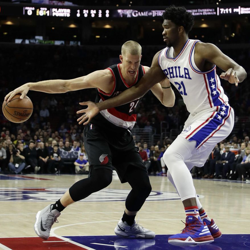 Portland Trail Blazers' Mason Plumlee, left, tries to dribble around Philadelphia 76ers' Joel Embiid during the first half of an NBA basketball game, Friday, Jan. 20, 2017, in Philadelphia. (AP Photo/Matt Slocum)